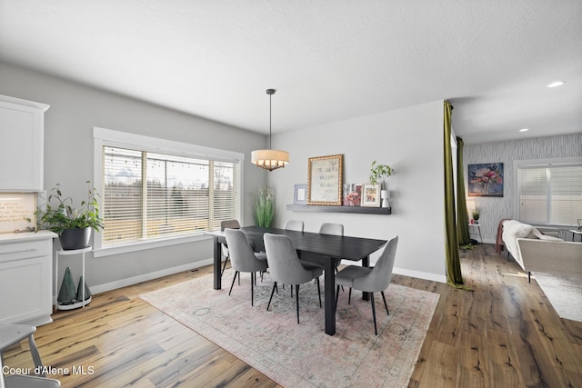 dining space featuring recessed lighting, baseboards, light wood-style floors, and a textured ceiling