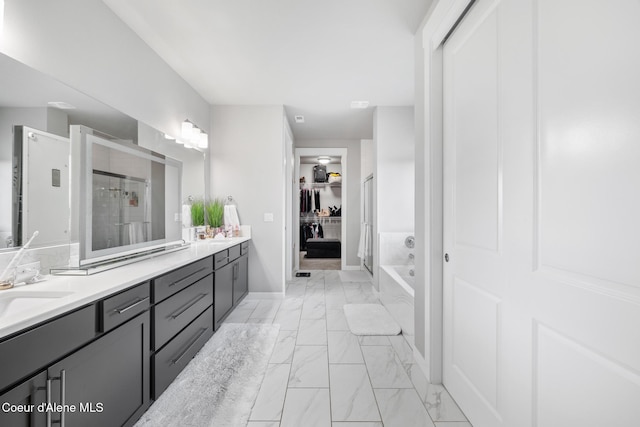 full bathroom featuring marble finish floor, a sink, a shower stall, double vanity, and a bath