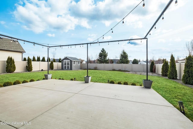view of patio with an outbuilding, a storage unit, and a fenced backyard