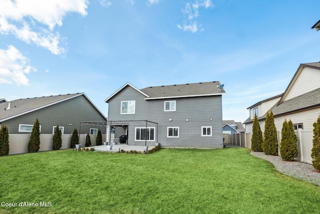 rear view of property with a patio, a lawn, a pergola, and a fenced backyard