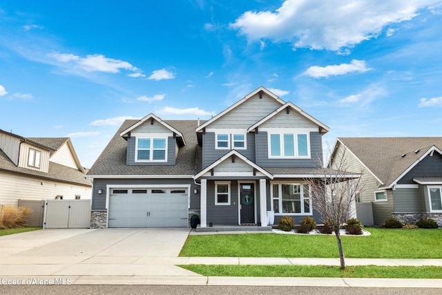 craftsman house with a front lawn, a gate, fence, and concrete driveway