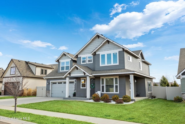 craftsman-style house with a front lawn, fence, roof with shingles, concrete driveway, and a garage