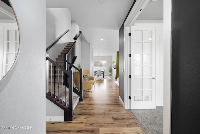entryway featuring stairway, baseboards, and wood finished floors