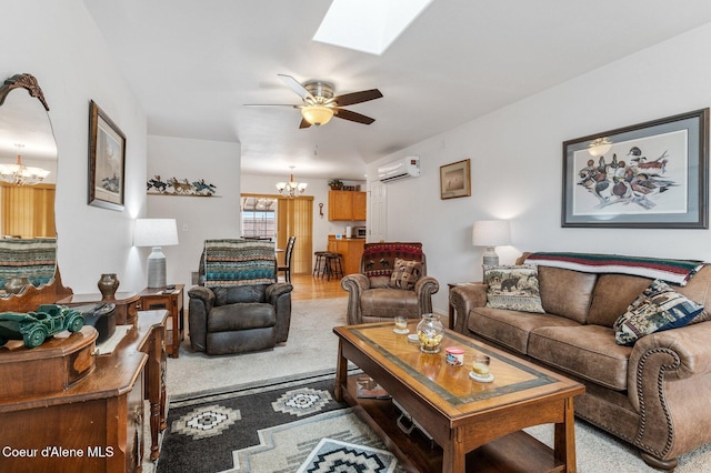 living room with a skylight, ceiling fan with notable chandelier, and a wall mounted air conditioner