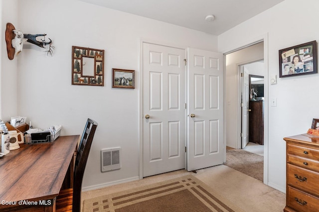 office area with baseboards and light carpet