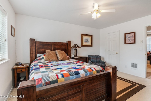 bedroom with carpet flooring, a ceiling fan, visible vents, and baseboards