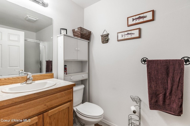 bathroom with visible vents, a shower stall, vanity, and toilet