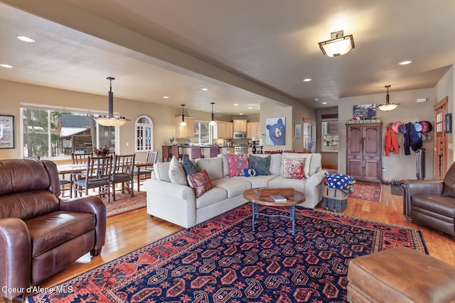 living room with recessed lighting and light wood-style floors