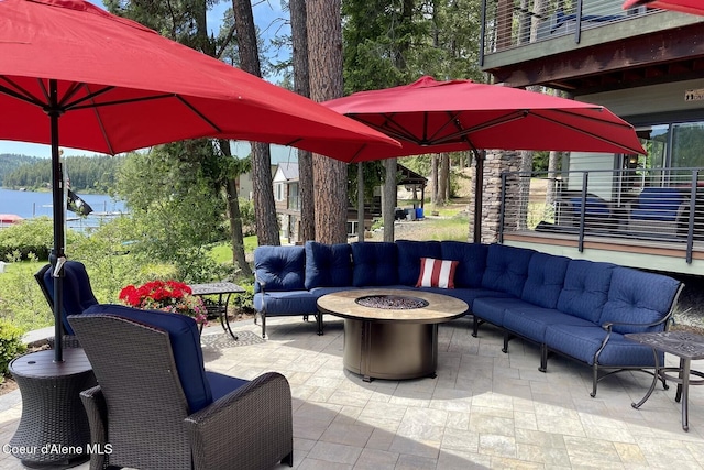 view of patio / terrace with an outdoor living space with a fire pit