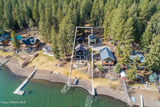 aerial view with a water view and a wooded view