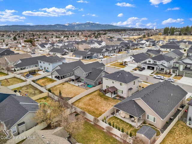 birds eye view of property with a mountain view and a residential view