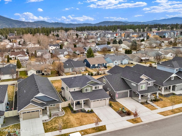 drone / aerial view featuring a residential view and a mountain view