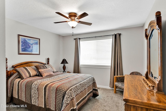 carpeted bedroom with baseboards, a textured ceiling, and ceiling fan