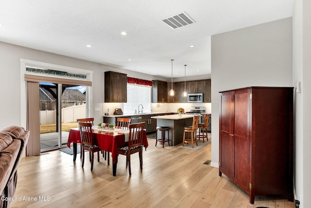 dining room with recessed lighting, visible vents, and light wood finished floors