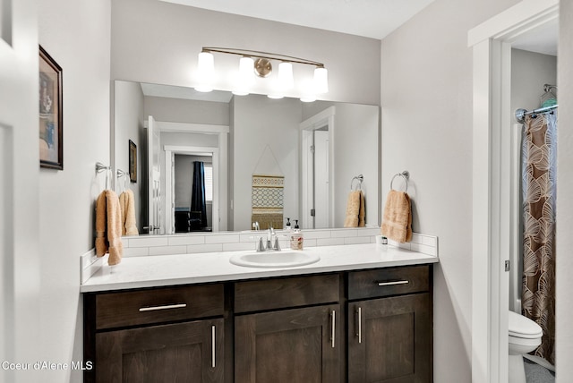 bathroom with vanity, a shower with shower curtain, and toilet