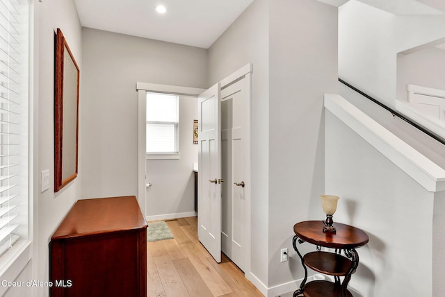 hall with recessed lighting, baseboards, and light wood finished floors