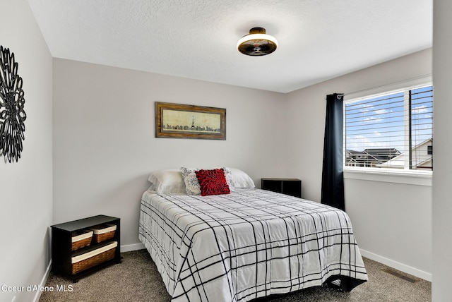 carpeted bedroom featuring visible vents, a textured ceiling, and baseboards