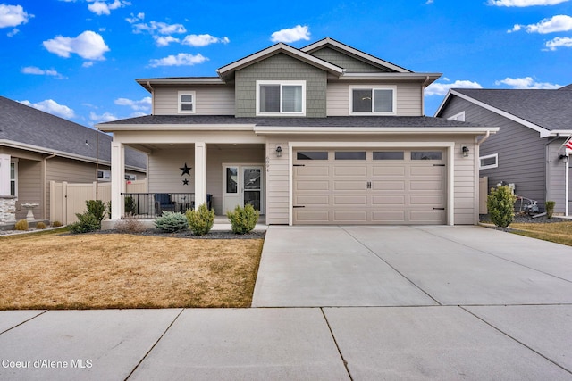 view of front facade featuring fence, a porch, concrete driveway, a front yard, and an attached garage