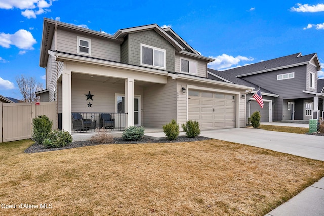 traditional-style home featuring covered porch, concrete driveway, a front yard, and fence