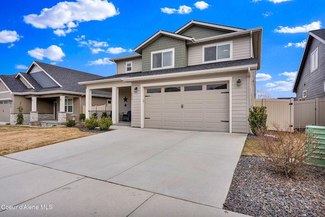 view of front of property with an attached garage, fence, covered porch, and driveway