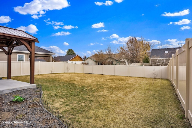 view of yard with a gazebo, a residential view, a patio area, and a fenced backyard