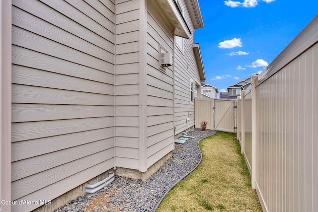 view of property exterior with a gate and fence