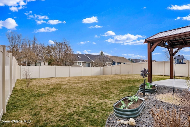 view of yard featuring a gazebo, a fenced backyard, and a patio area