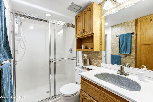 full bath featuring visible vents, toilet, a stall shower, and vanity