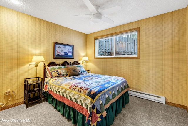 bedroom with a baseboard heating unit, baseboards, ceiling fan, carpet flooring, and a textured ceiling