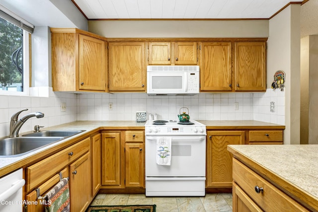 kitchen featuring a sink, white appliances, tasteful backsplash, and ornamental molding