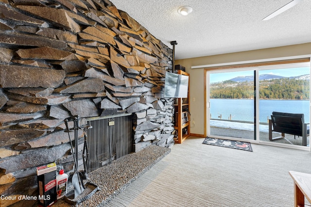 carpeted living room with a fireplace, a textured ceiling, and baseboards