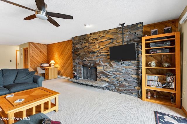 living area with wood walls, carpet floors, and a textured ceiling