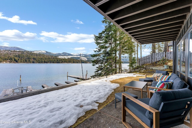 view of patio / terrace with a water and mountain view