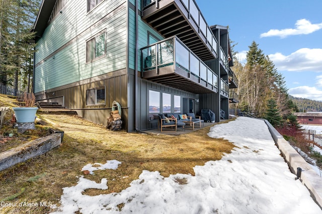 rear view of property with a patio area and a balcony