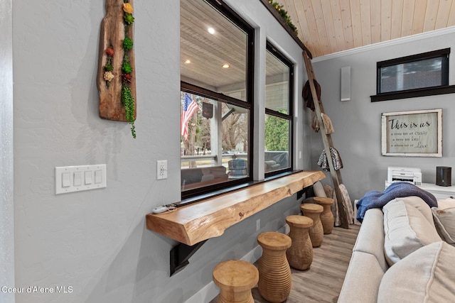 living area with recessed lighting, wooden ceiling, crown molding, and wood finished floors