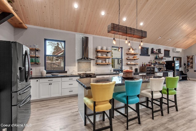 kitchen with wall chimney range hood, wood ceiling, decorative backsplash, black refrigerator with ice dispenser, and open shelves