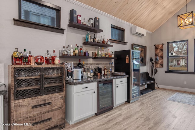 bar with light wood-type flooring, beverage cooler, wooden ceiling, a dry bar, and vaulted ceiling