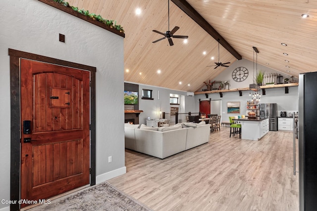 living area featuring high vaulted ceiling, beam ceiling, ceiling fan, wood ceiling, and light wood-style floors