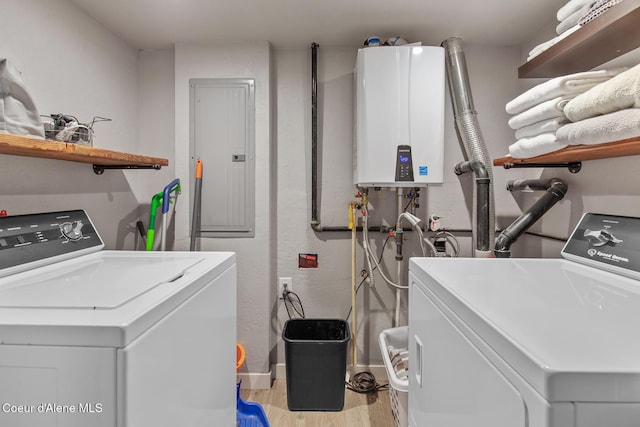 washroom featuring electric panel, separate washer and dryer, laundry area, and water heater