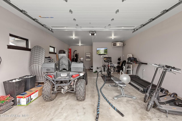 garage with a garage door opener and a wall unit AC