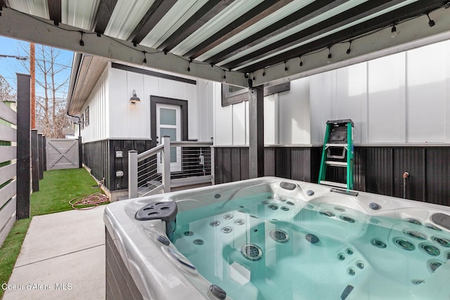 view of patio with fence and a hot tub