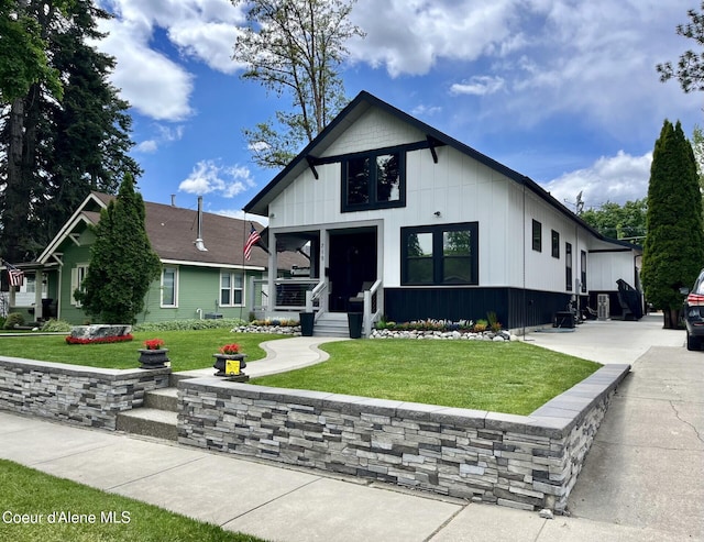 715 N Government Way, Coeur Dalene, ID 83814 - view of front of home with a front lawn and board and batten siding