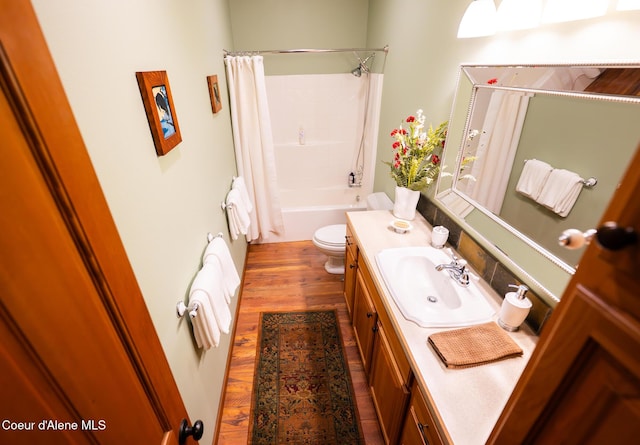 full bathroom with vanity, toilet, wood finished floors, and shower / bath combo