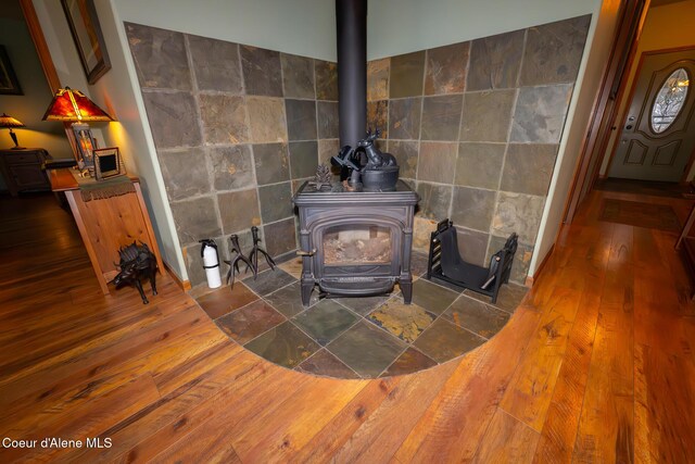 room details featuring wood finished floors and a wood stove