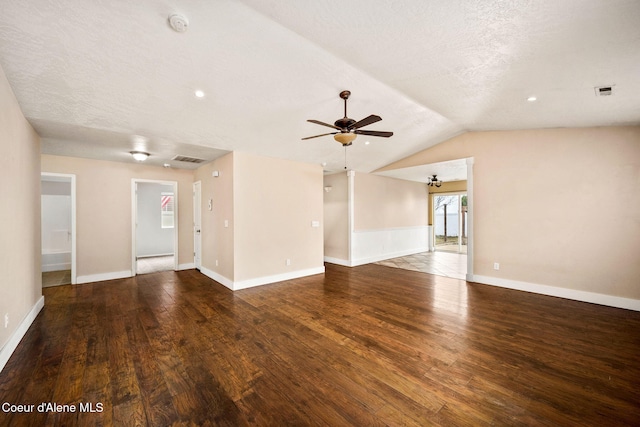 empty room featuring vaulted ceiling, wood finished floors, visible vents, and baseboards