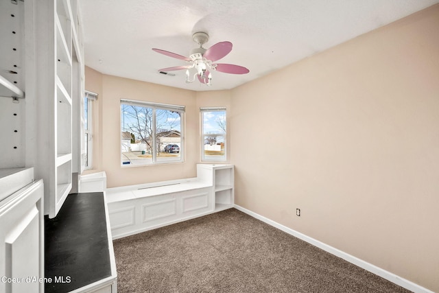 interior space with visible vents, carpet, baseboards, and ceiling fan