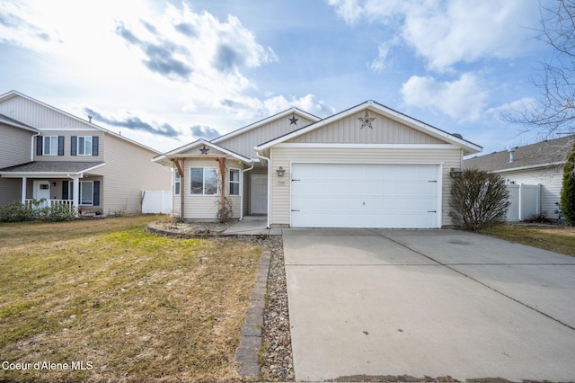 view of front of property with driveway, a front lawn, fence, covered porch, and an attached garage