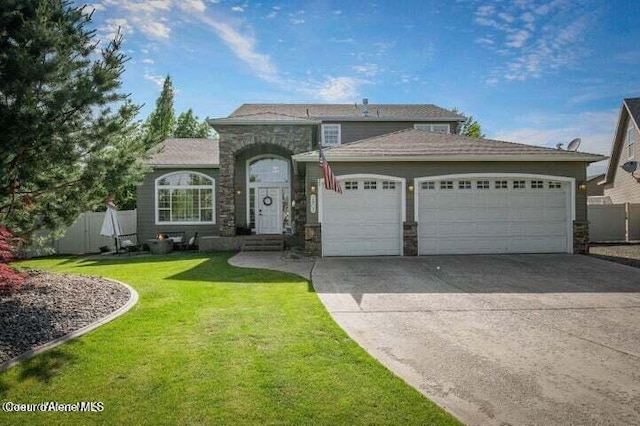 view of front of home featuring a front yard, concrete driveway, a garage, and fence