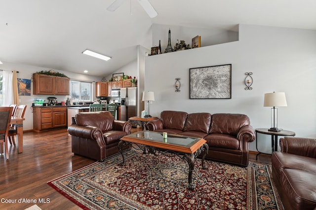 living area featuring ceiling fan, plenty of natural light, lofted ceiling, and dark wood-style floors