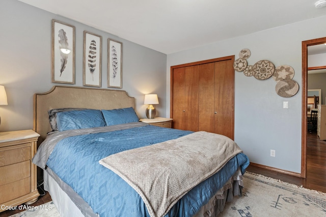 bedroom with a closet, baseboards, and wood finished floors